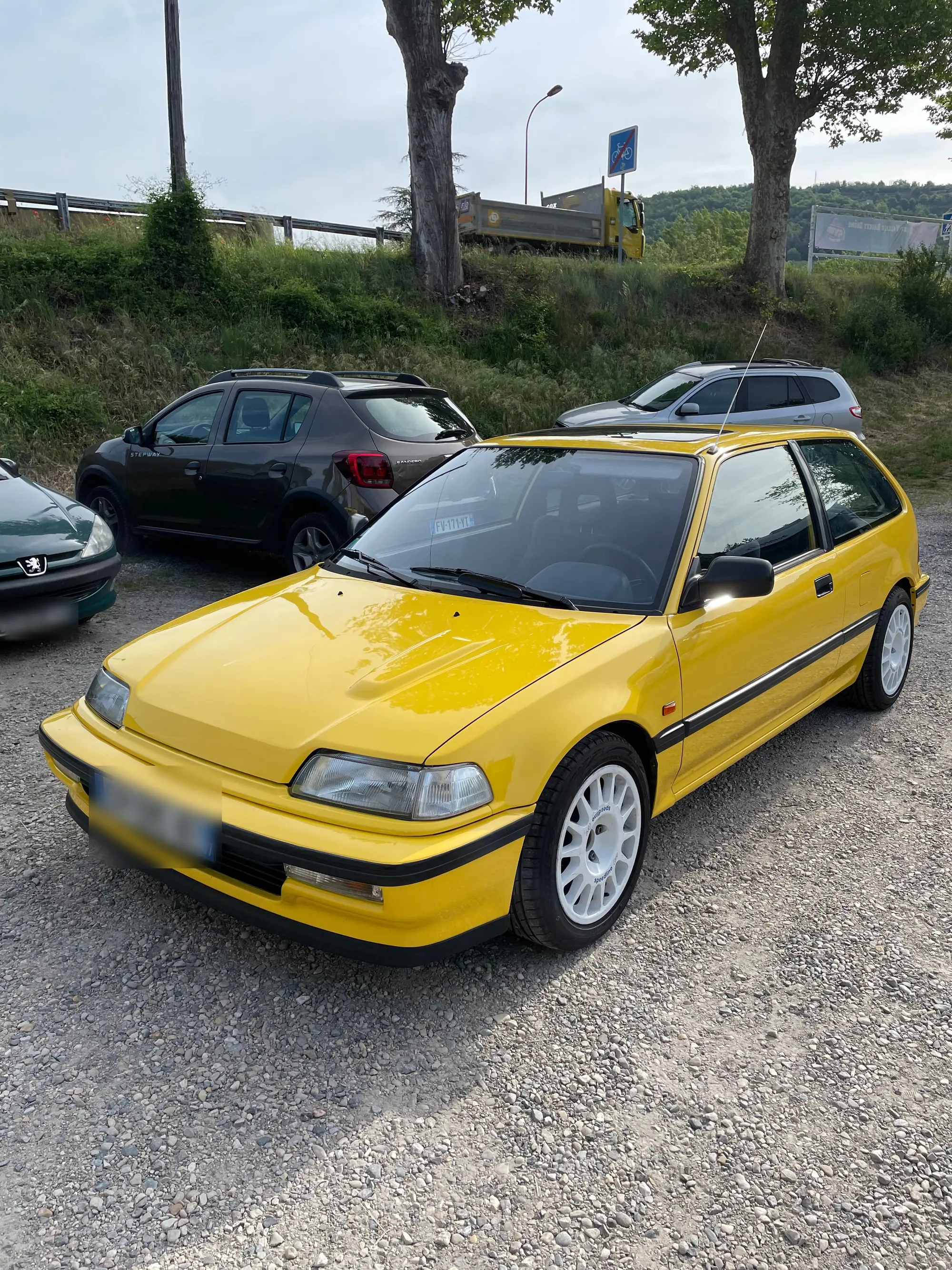 Honda Civic jaune trois portes, jantes blanches